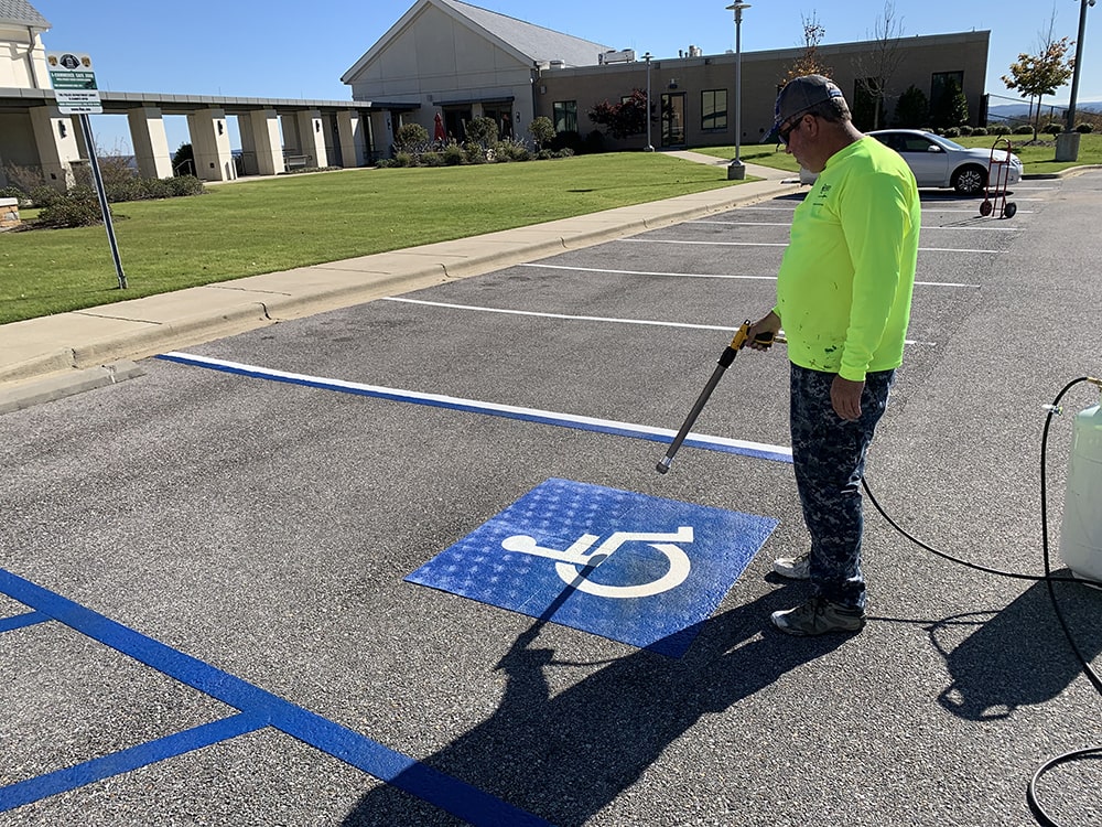G-FORCE North Alabama team member marking a handicap stall at Vestavia Hills Police Department