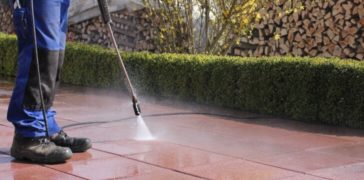 employee completing pressure washing services