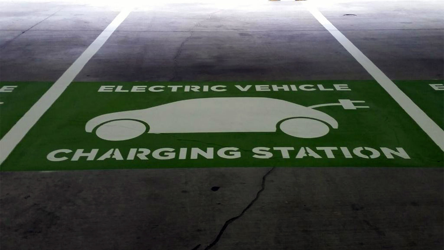 green electric vehicle charging station stencil in Atlanta, GA