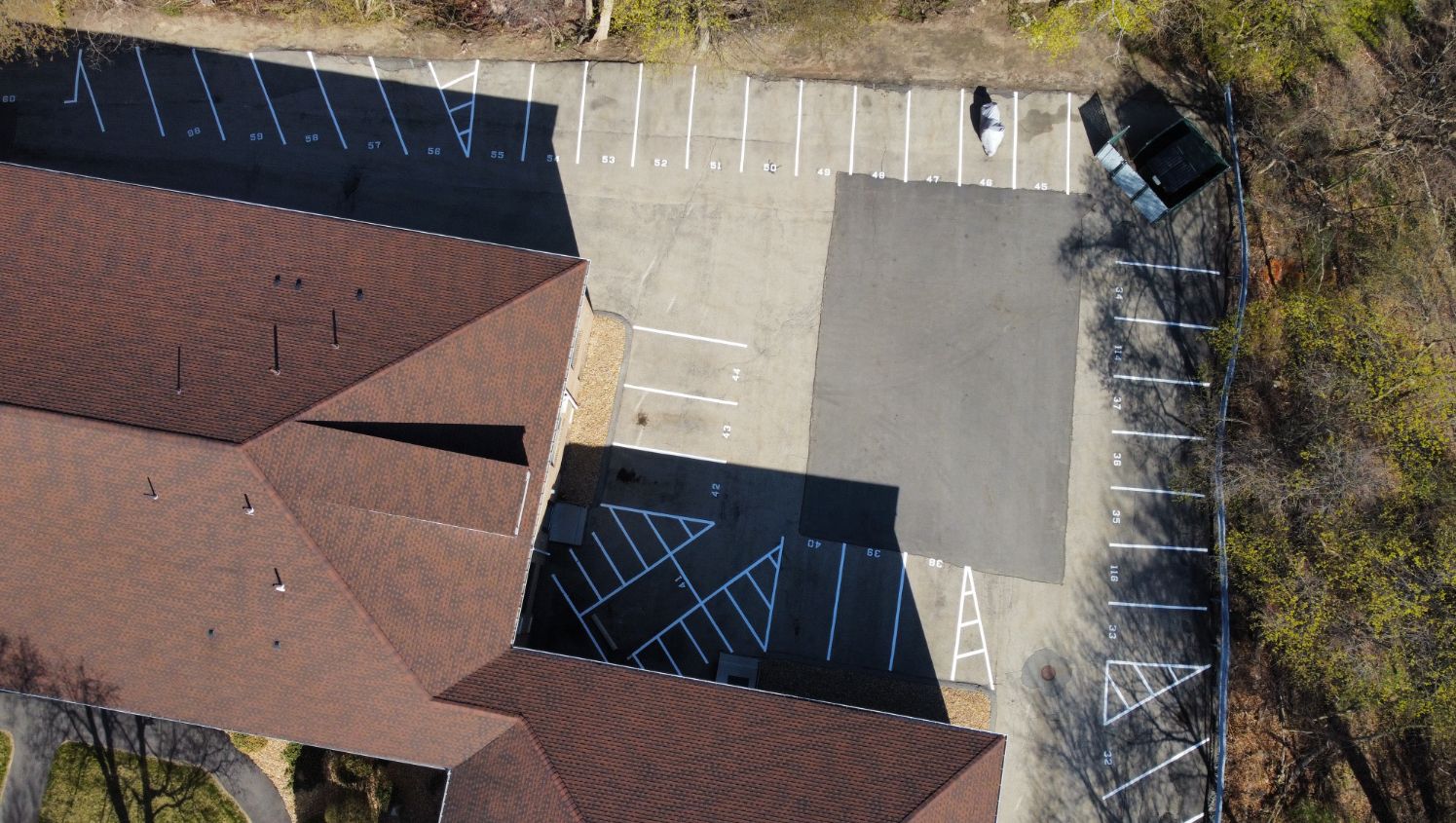 an aerial view of newly striped parking stalls