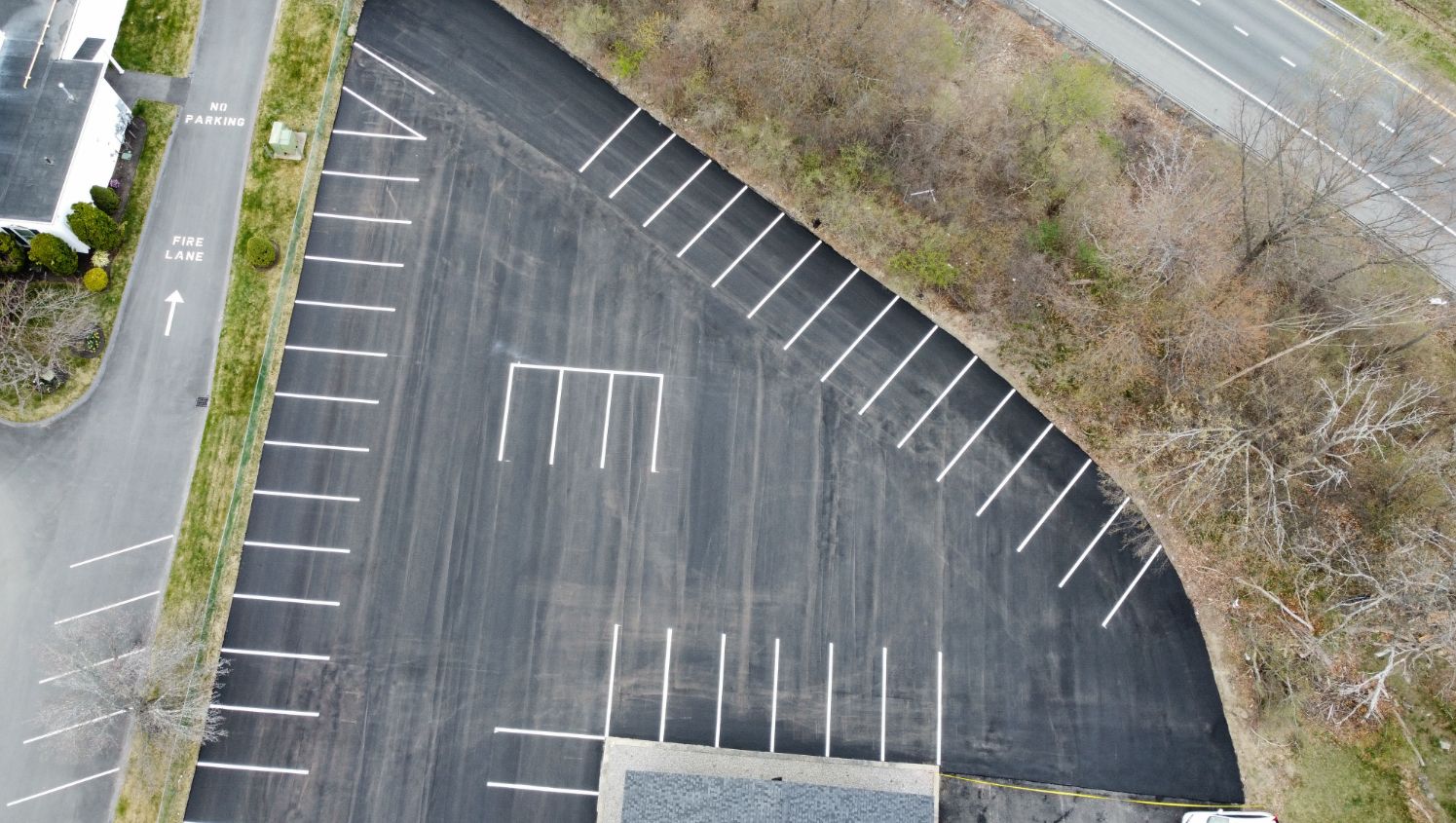 an aerial view of pavement with parking stalls