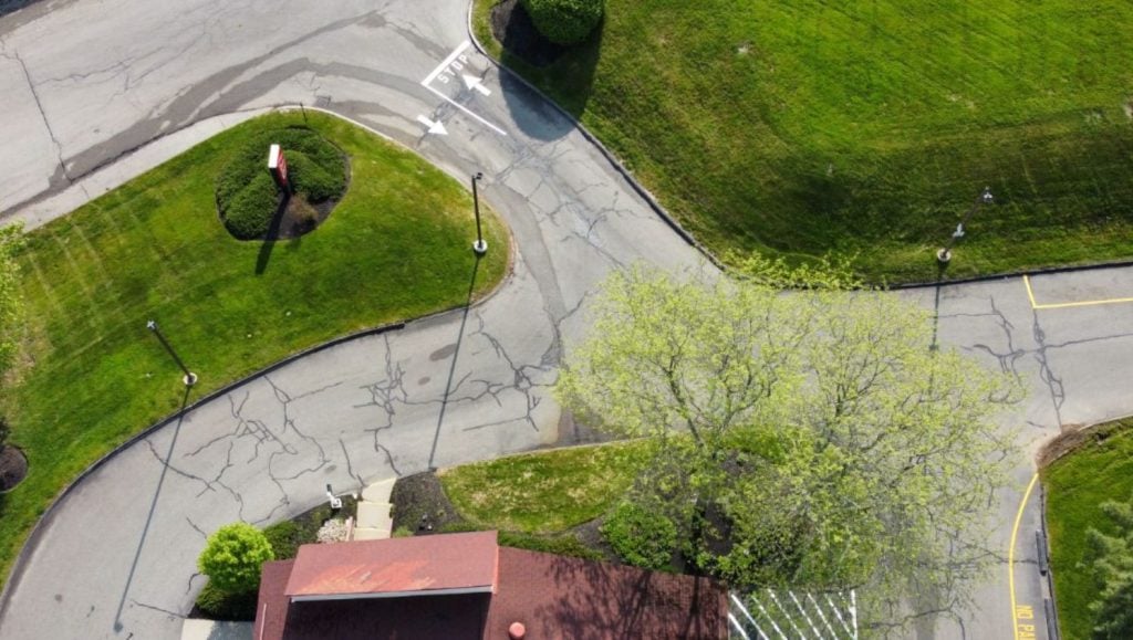 an aerial view of filled cracks in pavement