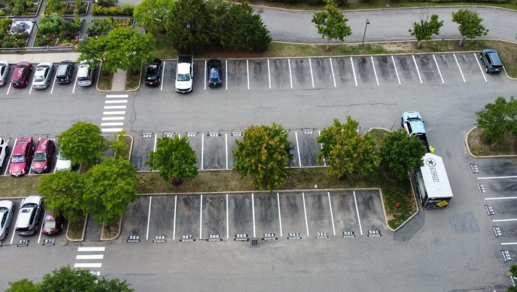 Brooksby Village parking lot freshly painted line striping aerial view