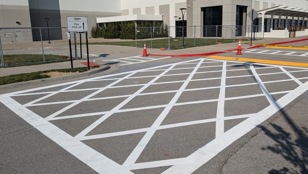 close-up white line striping freshly painted for Amazon parking lot