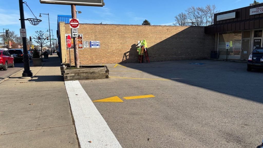 freshly painted yellow arrow on Dempster Commons Shopping Center parking lot