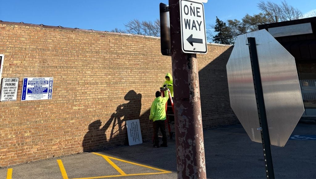 two G-FORCE employees installing signage