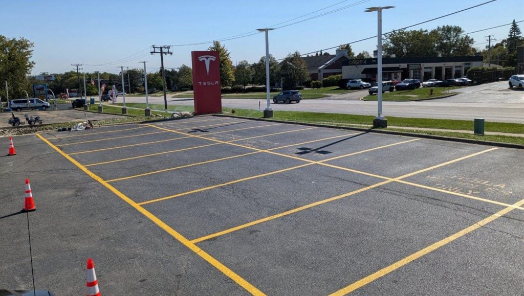 front view of Tesla Dealership parking lot with freshly painted parking spots