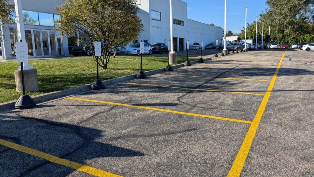 close-up of freshly painted line markings for Tesla Dealership parking lot