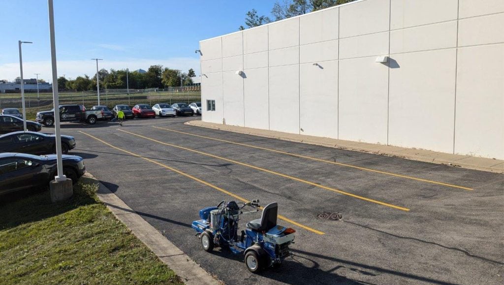 side view of line markings freshly painted for Tesla Dealership