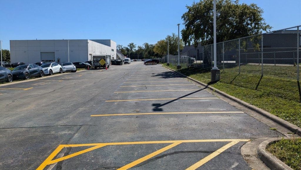 freshly painted parking spots for Tesla Dealership parking lot
