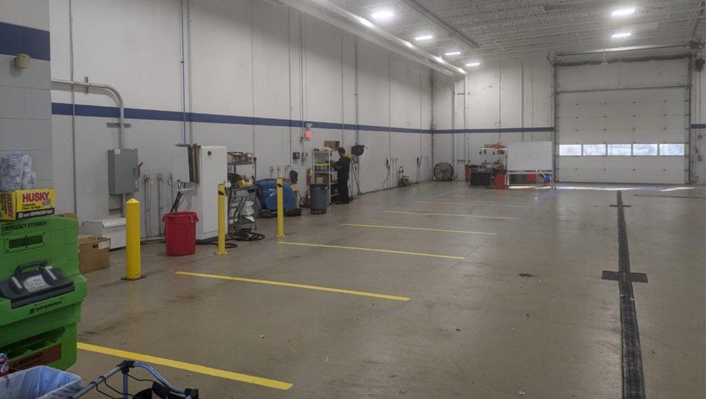 freshly painted yellow line markings for Tesla Dealership warehouse