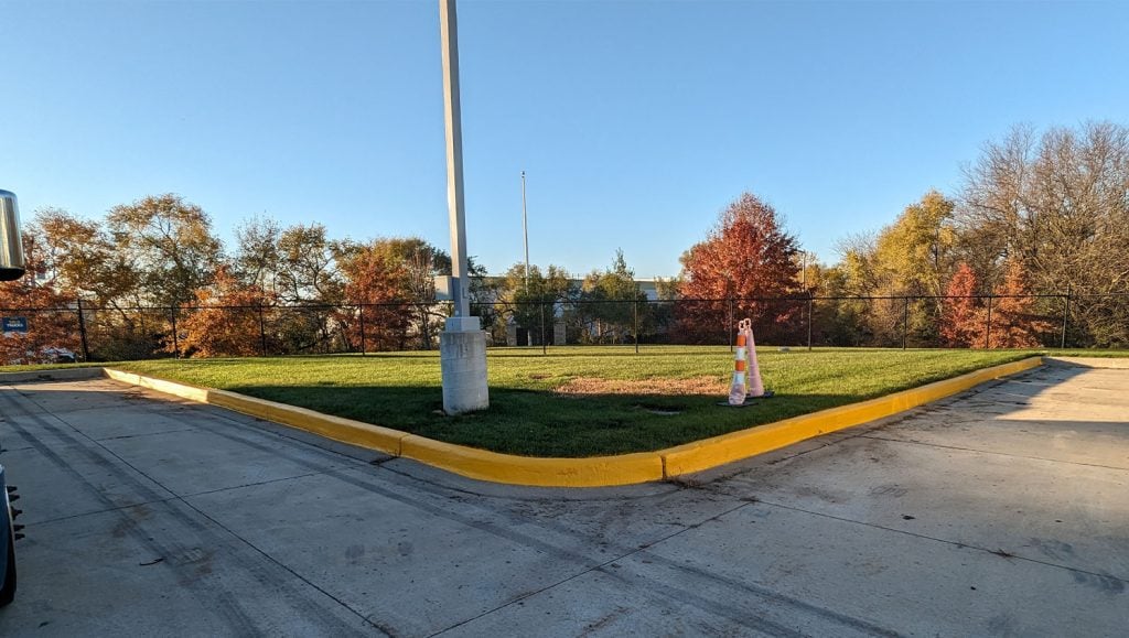 close-up of curb freshly painted for Werner Transportation parking lot