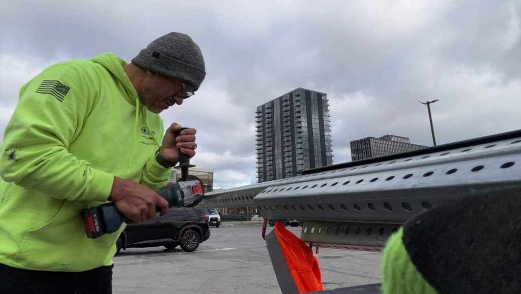 close-up of g-force employee cutting sign