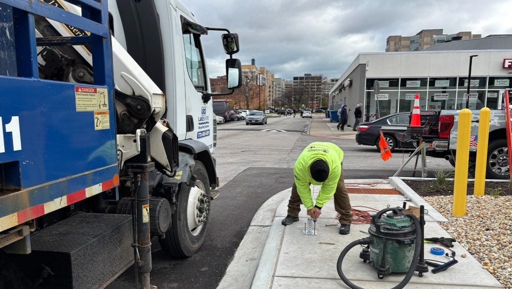 g-force employee installing sign for East Lake Management