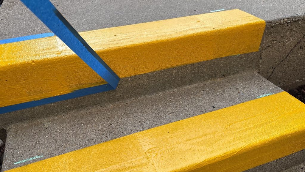 close-up of yellow painted stairs freshly painted for St. Paul Condominium Association