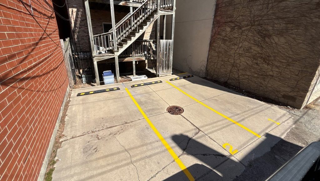 parking stops installed for St. Paul Condominium Association parking lot
