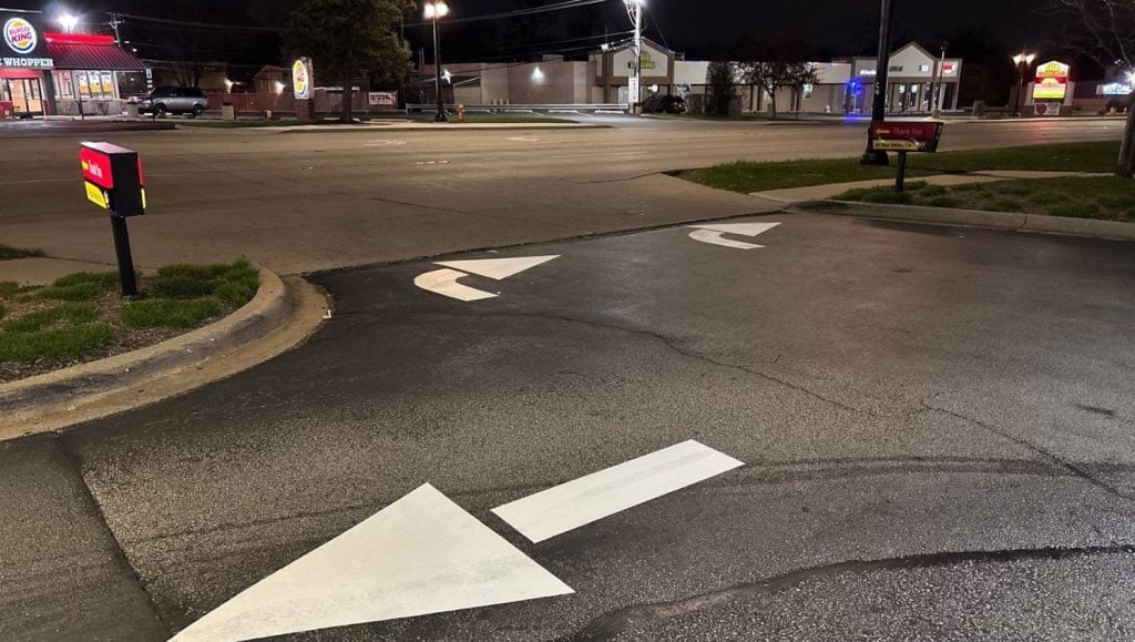 freshly painted white arrows for McDonalds parking lot