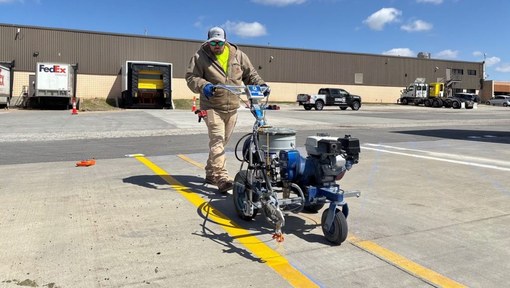 G-FORCE® employee freshly painting FedEx Grounds parking lot