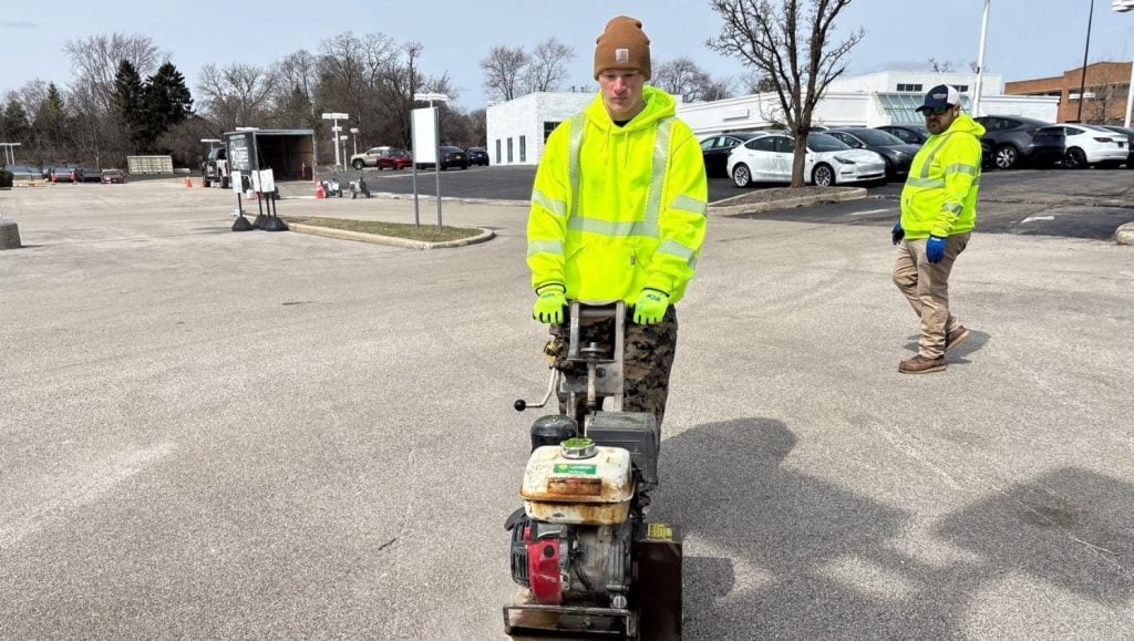 G-FORCE employee using line marking machine