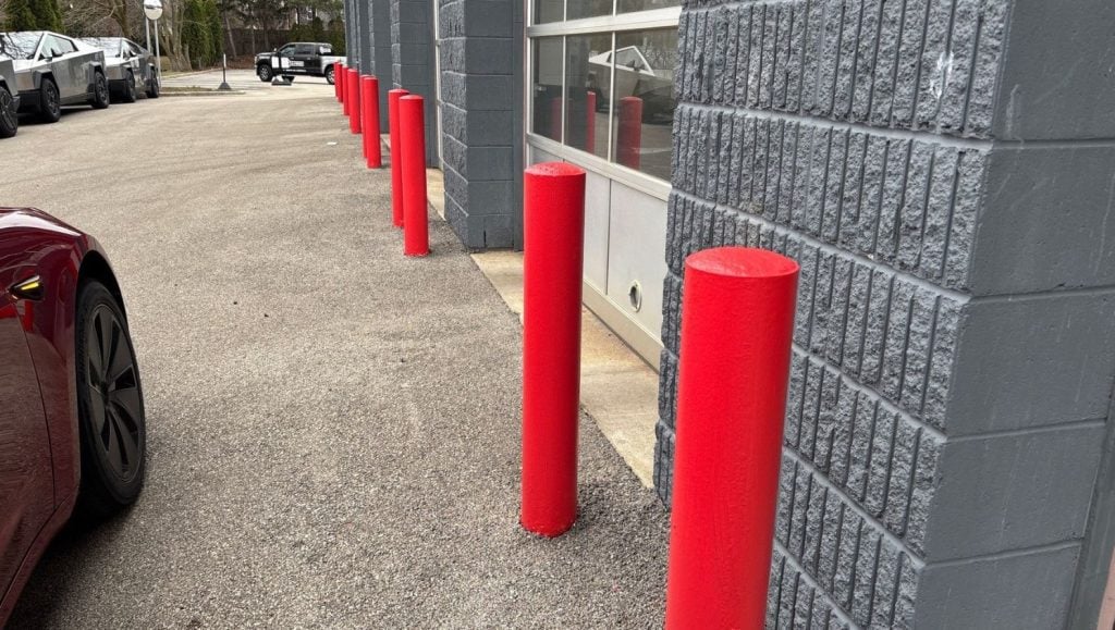 bollards freshly painted red for Tesla parking lot