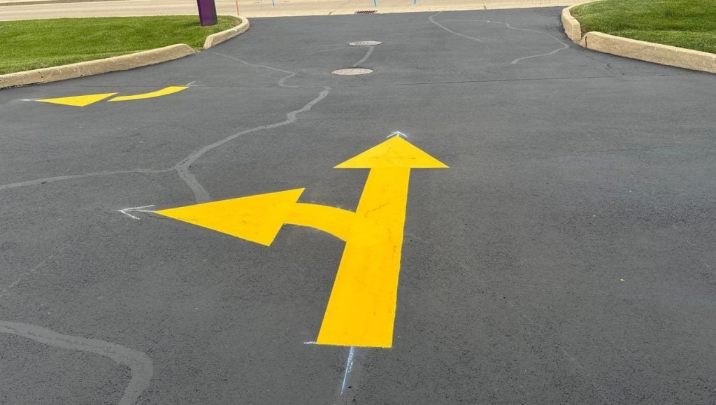 freshly painted yellow arrow close-up for Advia Credit Union parking lot