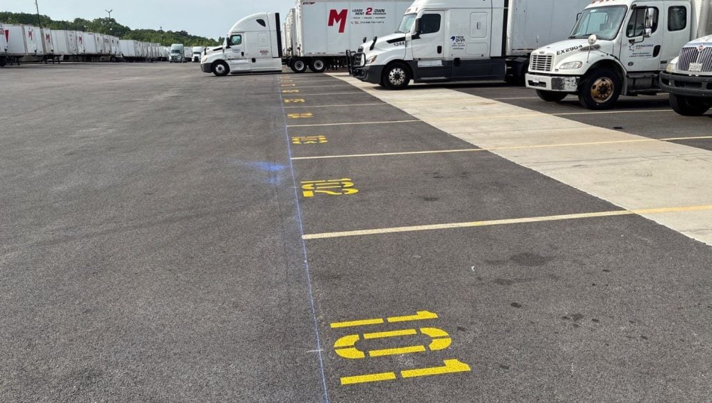 close-up of freshly painted numbers for Maybach International Group parking lot