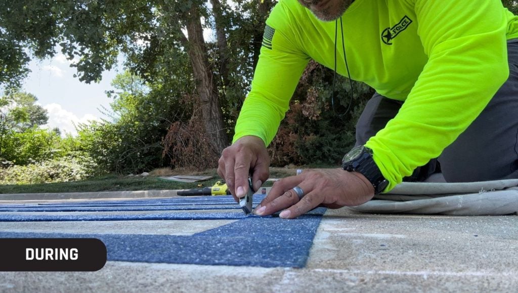 close-up of g-force employee painting new line markings