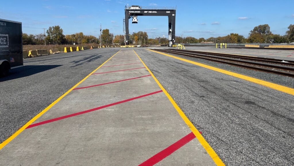 red and yellow line striping freshly painted for Norfolk Southern Railyard