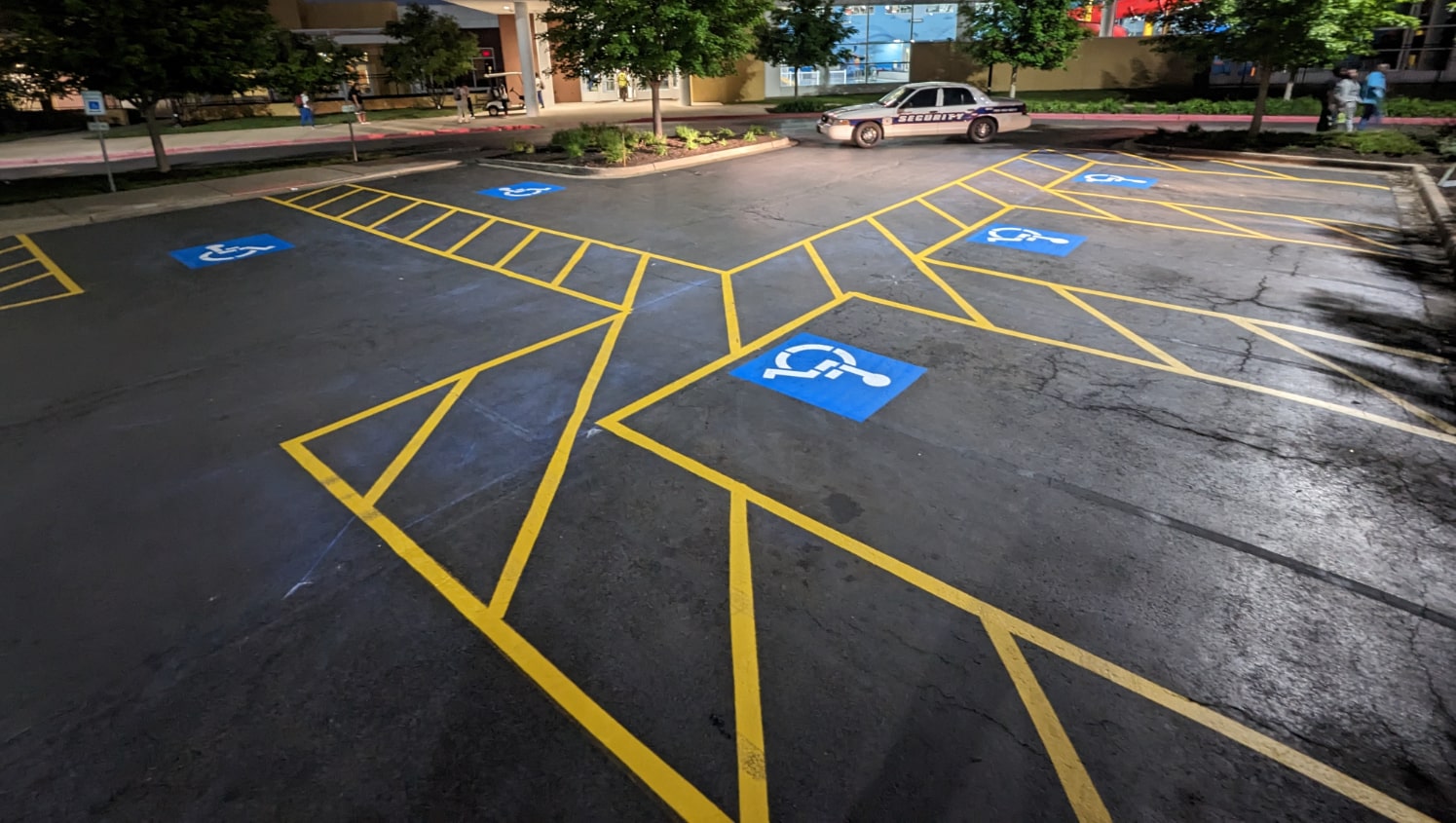 nighttime view of freshly marked ADA-compliant parking stalls and walkways