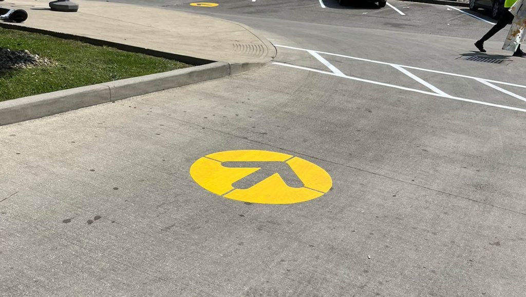 freshly painted yellow arrow for McDonald's Northern Kentucky parking lot