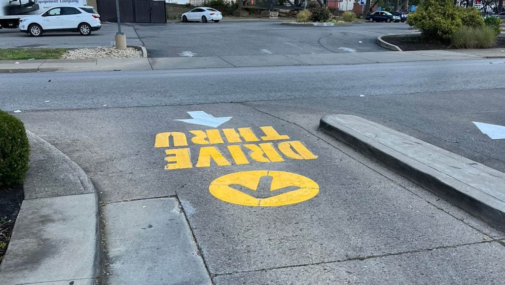 close-up of freshly painted arrow for McDonald's Northern Kentucky parking lot