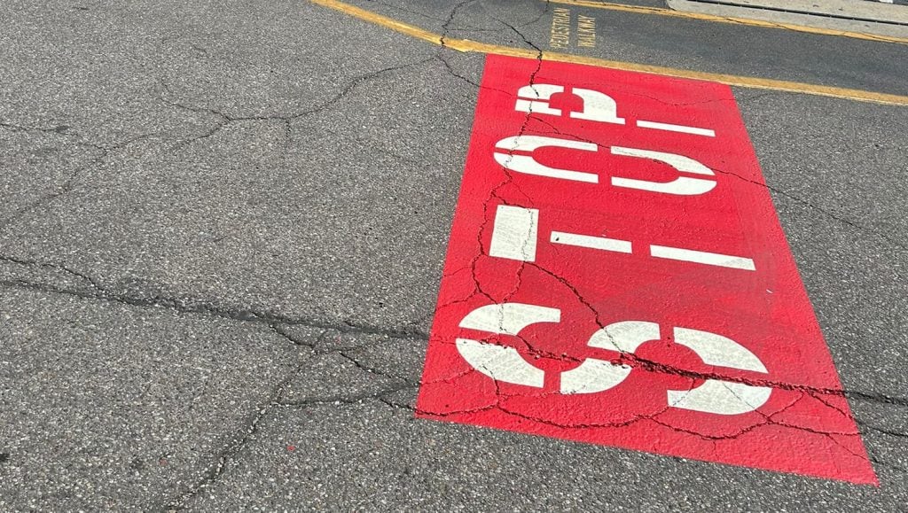 multiple no foot traffic paintings on Valvoline parking lot