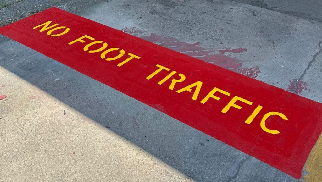 no foot traffic painted red on Valvoline parking lot