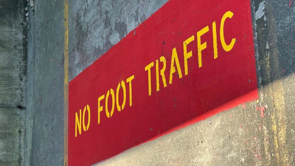 no foot traffic painted on Valvoline parking lot multiple times