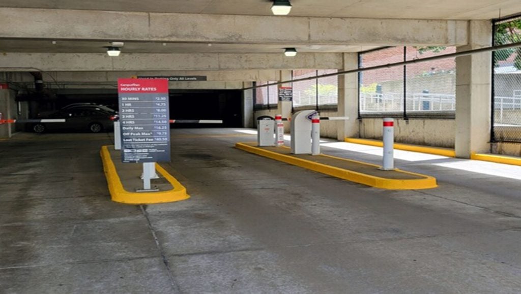 freshly painted yellow curbs at a parking garage entrance