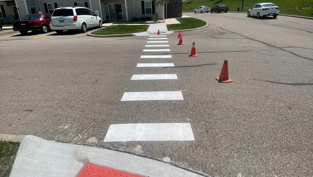 close-up of freshly painted white lines in parking lot for apartment complex