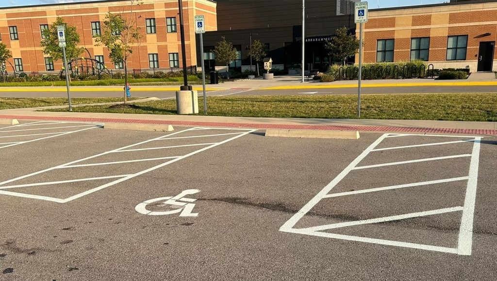 close-up of white arrow on parking lot