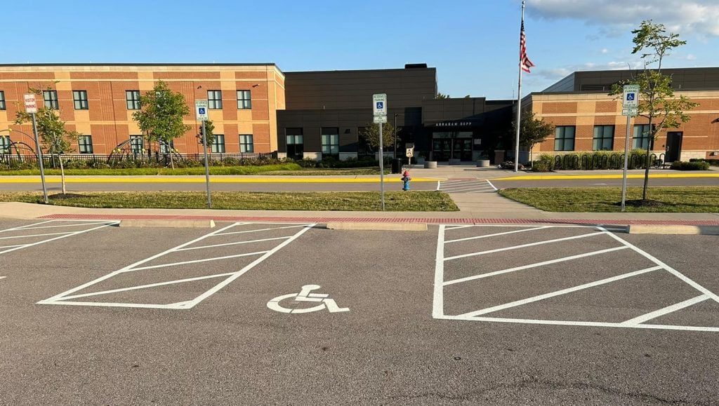 freshly painted white arrow and cross walk for Dublin City Schools parking lot