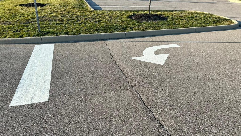 close-up of white arrow freshly painted on Dublin City Schools parking lot