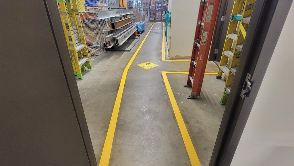 freshly painted yellow lines inside of warehouse