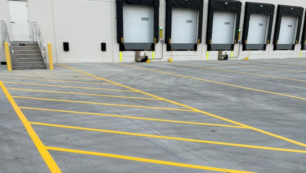 close-up of crosswalk and line markings freshly painted for DB Schenker parking lot