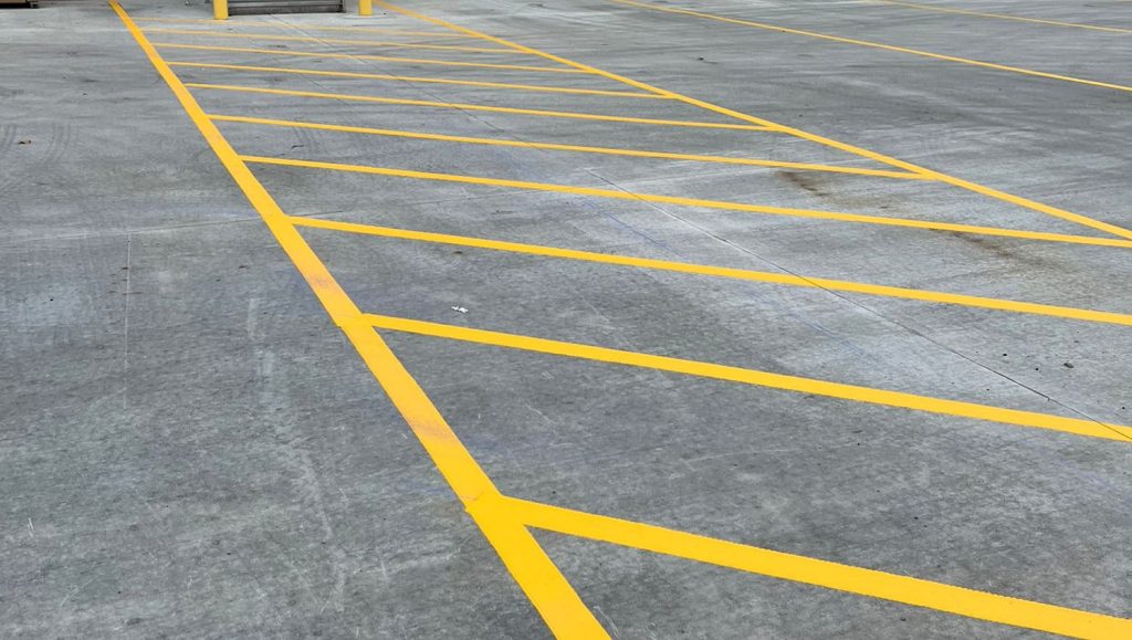 close-up of freshly painted crosswalk for DB Schenker parking lot
