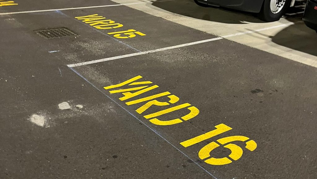 close-up of "yard 16" freshly painted on DB Schenker parking spot