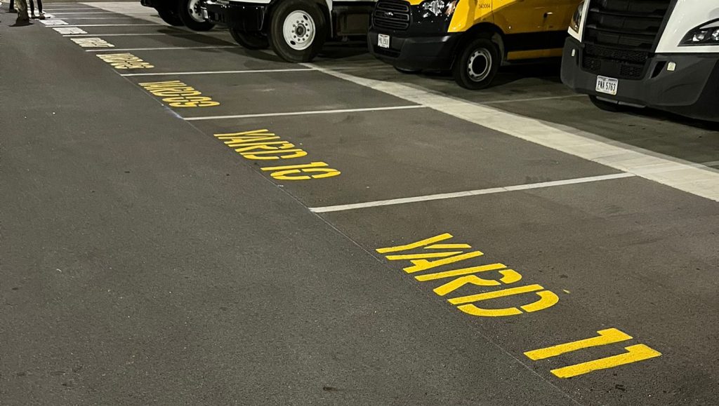 multiple parking spots freshly painted for DB Schenker parking lot