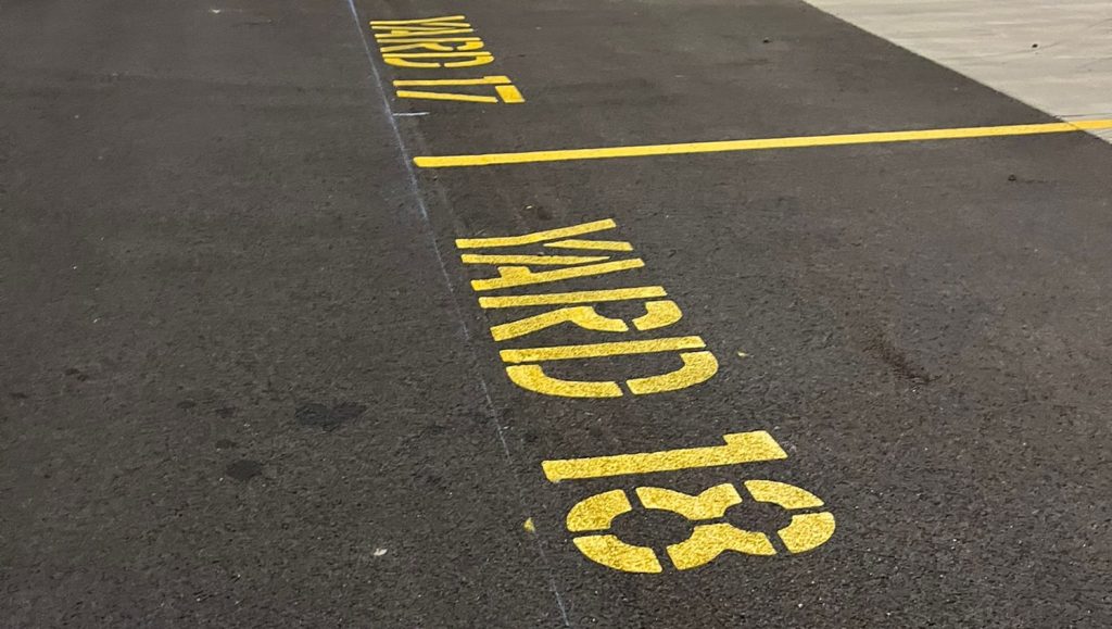 "yard 18" freshly painted on DB Schenker parking spot
