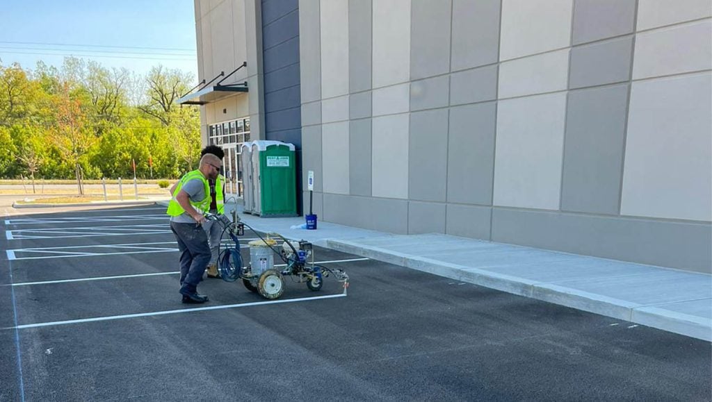 close-up of G-FORCE™ employee using line striping machine