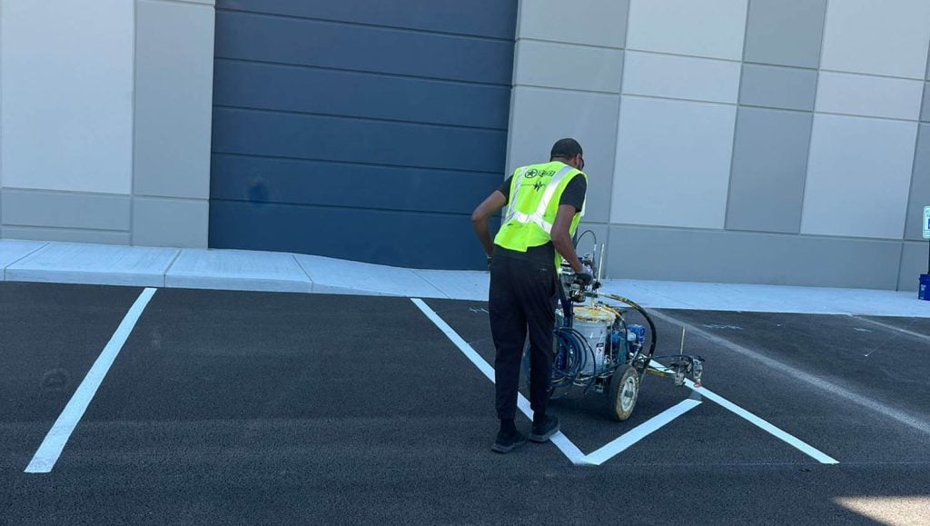 back view of G-FORCE™ employee line striping Stelzer Road Warehouse parking lot