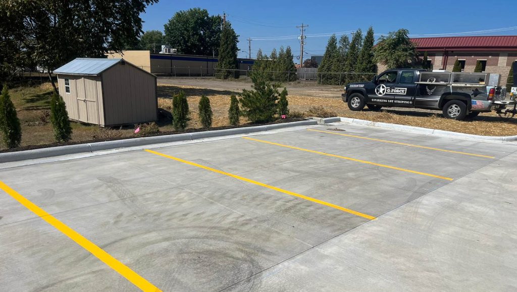 freshly painted yellow arrows for Take 5 Oil Change parking lot