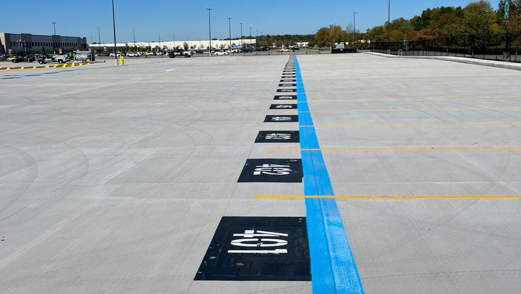 G-FORCE® employee installing parking stop for Amazon