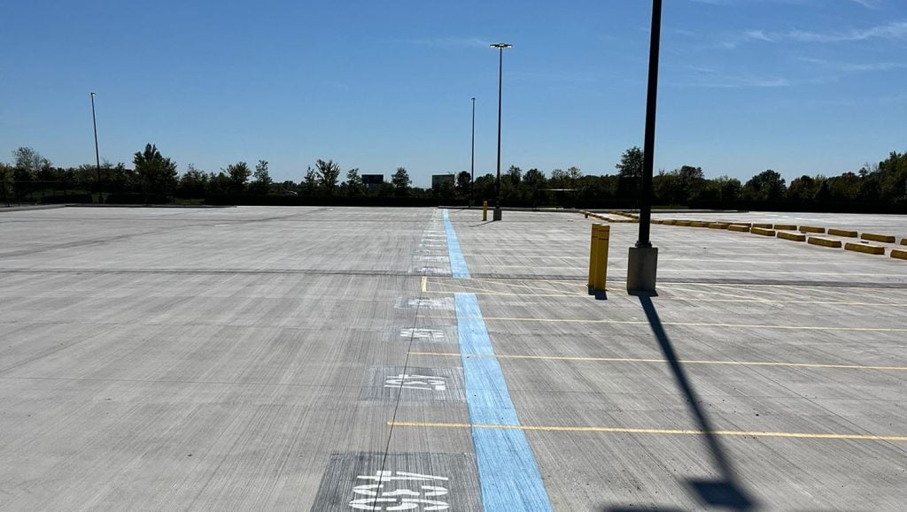 G-FORCE® crew installing parking stops for amazon parking lot